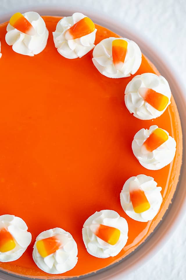 overhead of cheesecake showing half of the cheesecake on a white background