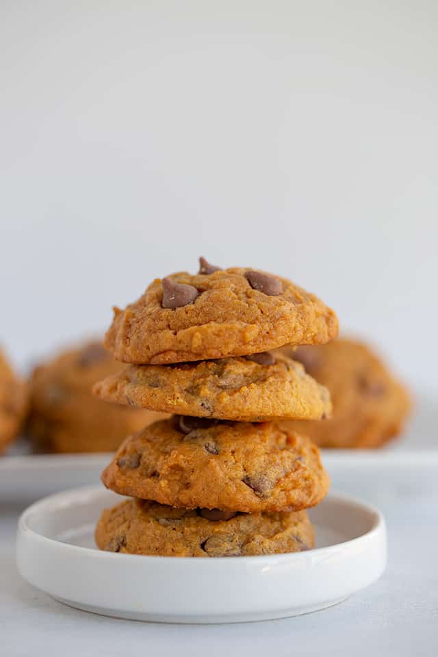 stack of pumpkin chocolate chip cookies on a small white plate