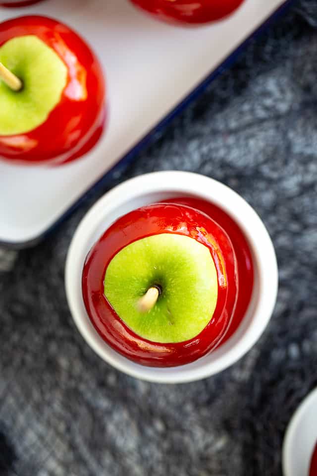 overhead photo of a candied apple on a small white cupcake stand