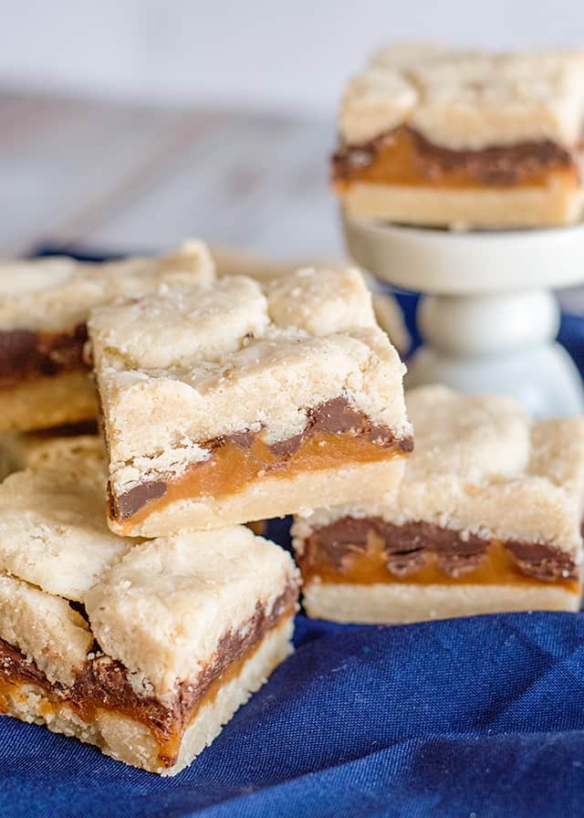 shortbread bars stacked with a blue linen