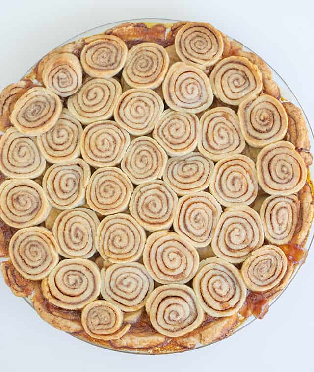 baked cinnamon swirled pie crust on a white background