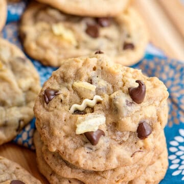 stack of cookies on a cutting board with a blue linen