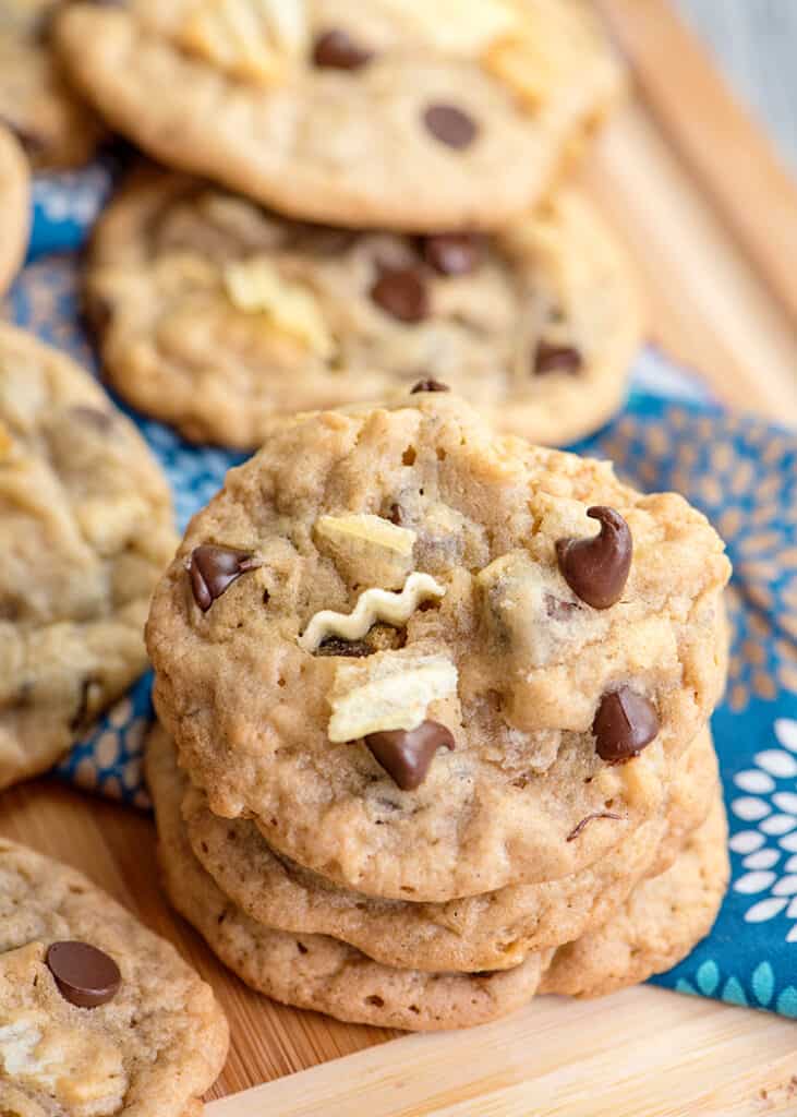 stack of cookies on a cutting board with a blue linen