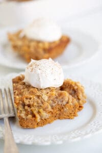 pumpkin crisp on a white lace plate with a fork