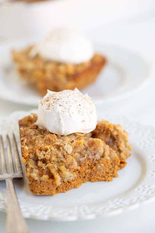 pumpkin crisp on a white lace plate with a fork
