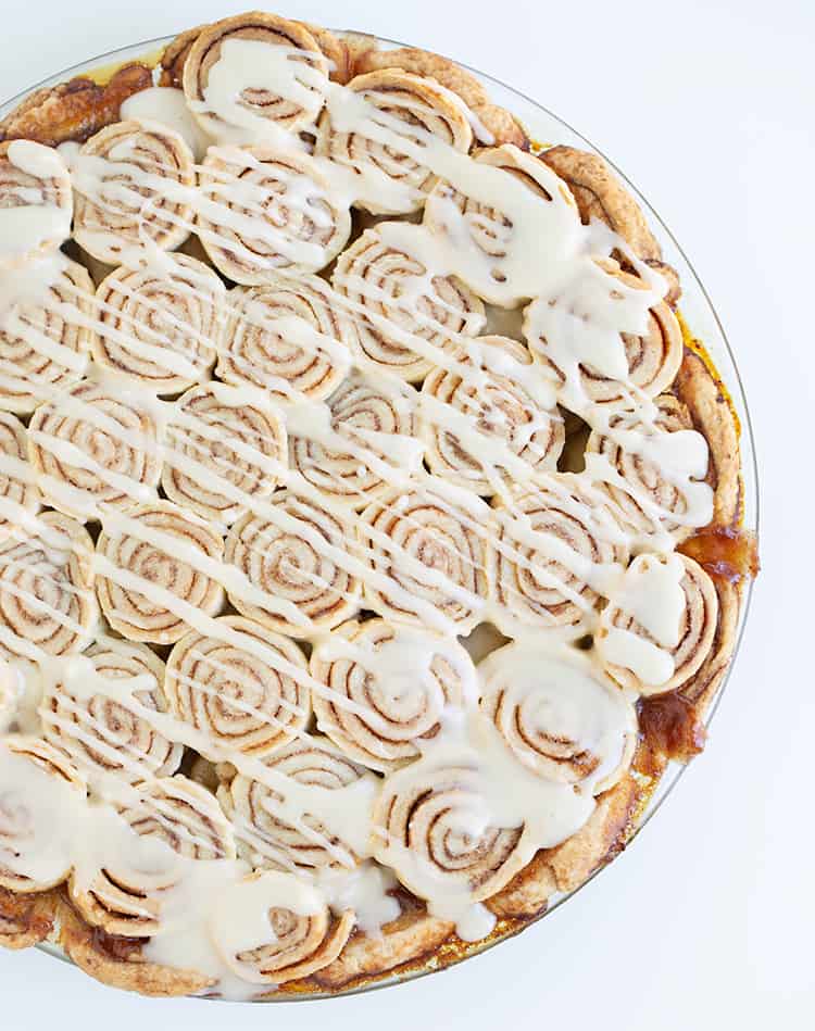 overhead photo of apple pie with a cream cheese glaze drizzled on top