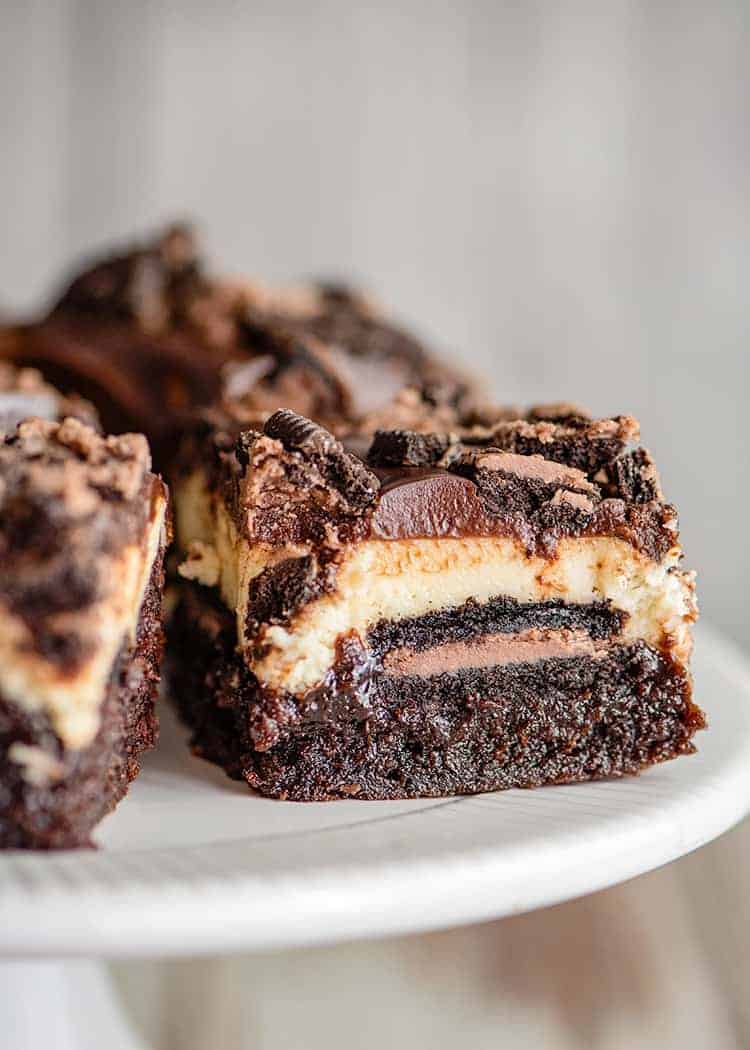 closeup of a brownie bar on a white cake plate