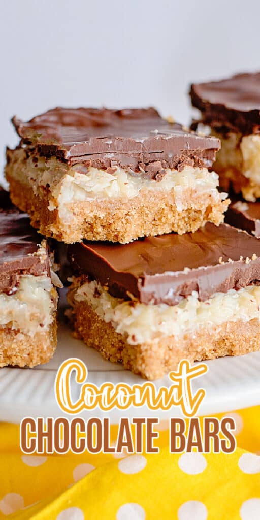 zoomed in photo of stacked coconut chocolate bars on a white cake plate with text at the bottom