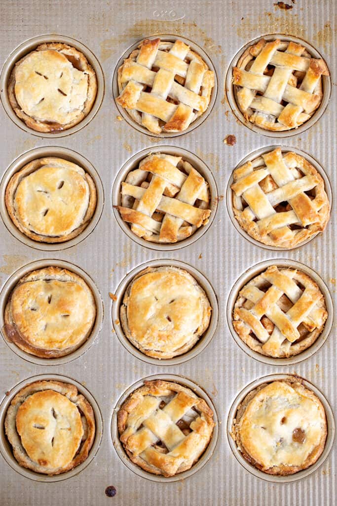 baked mini apple pies still in the cupcake pan