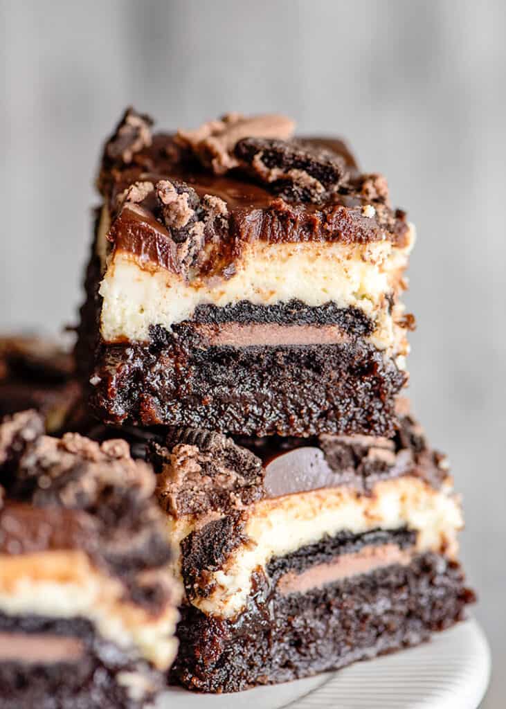 stacked brownie bars with a gray background