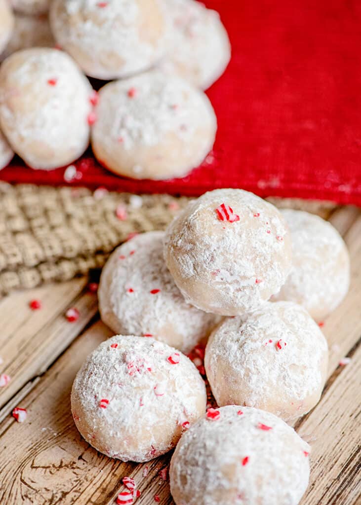 cookies on a wooden surface with a red linen behind the cookies