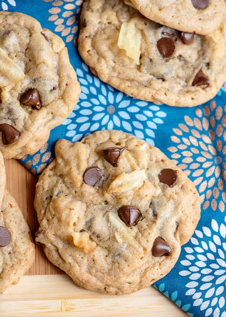 close up of a cookie on a blue fabric showing the wavy chips and chocolate chips