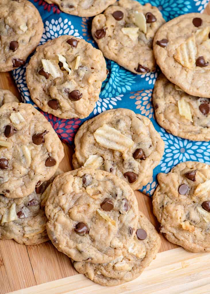 cookies scattered across a cutting board with a blue linen on it