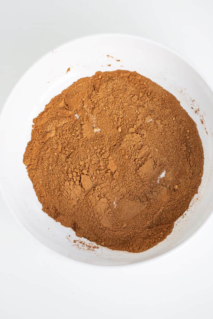 spices mixed together in a large bowl on a white surface