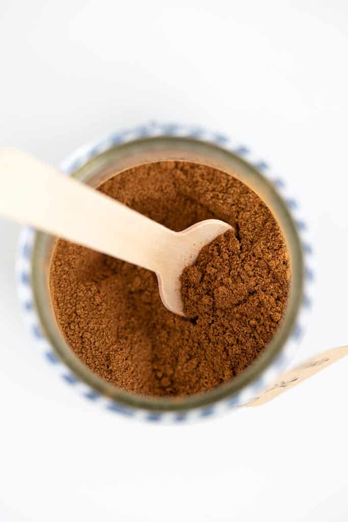 wooden spoon in a small glass jar of pumpkin pie spice