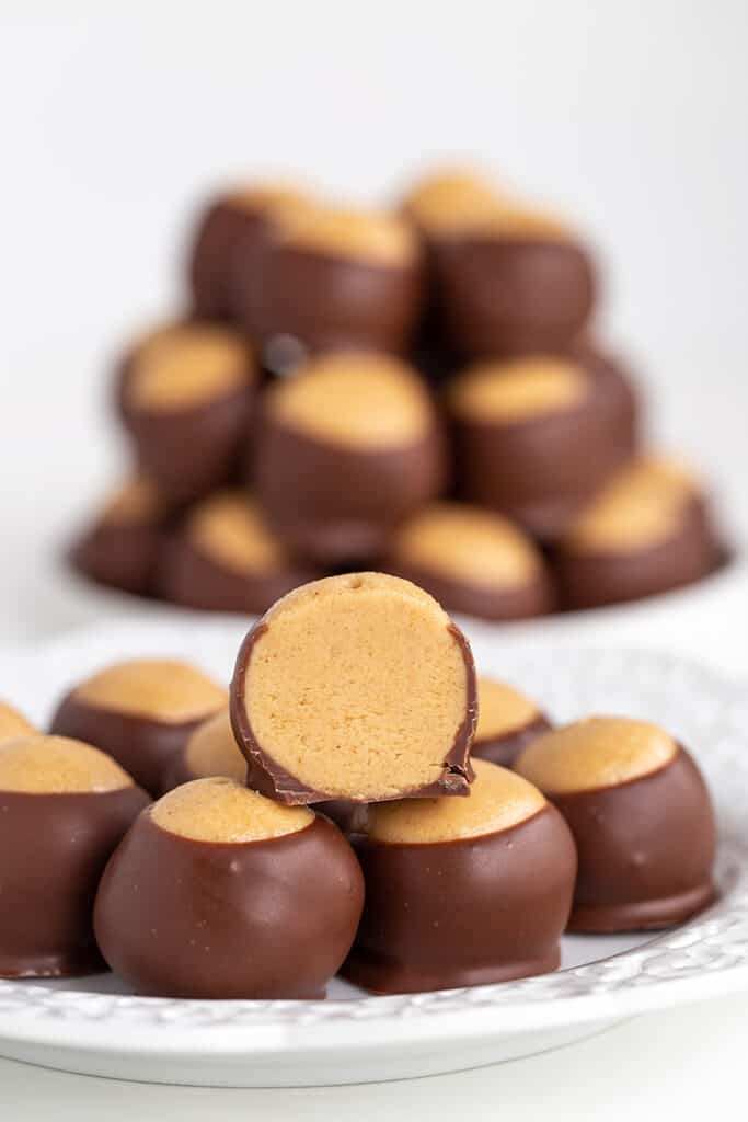 plate full of buckeyes with one sliced in half and sitting on top