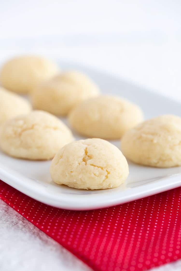 cookies on a white platter with a red polka dotted fabric under it