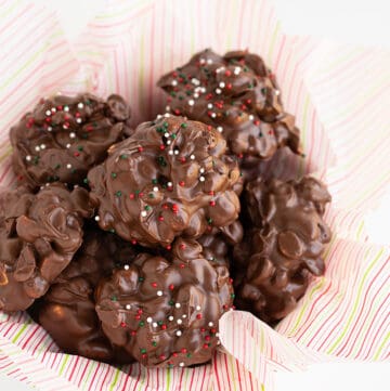 overhead photo of crockpot candy in a parchment lined white bowl