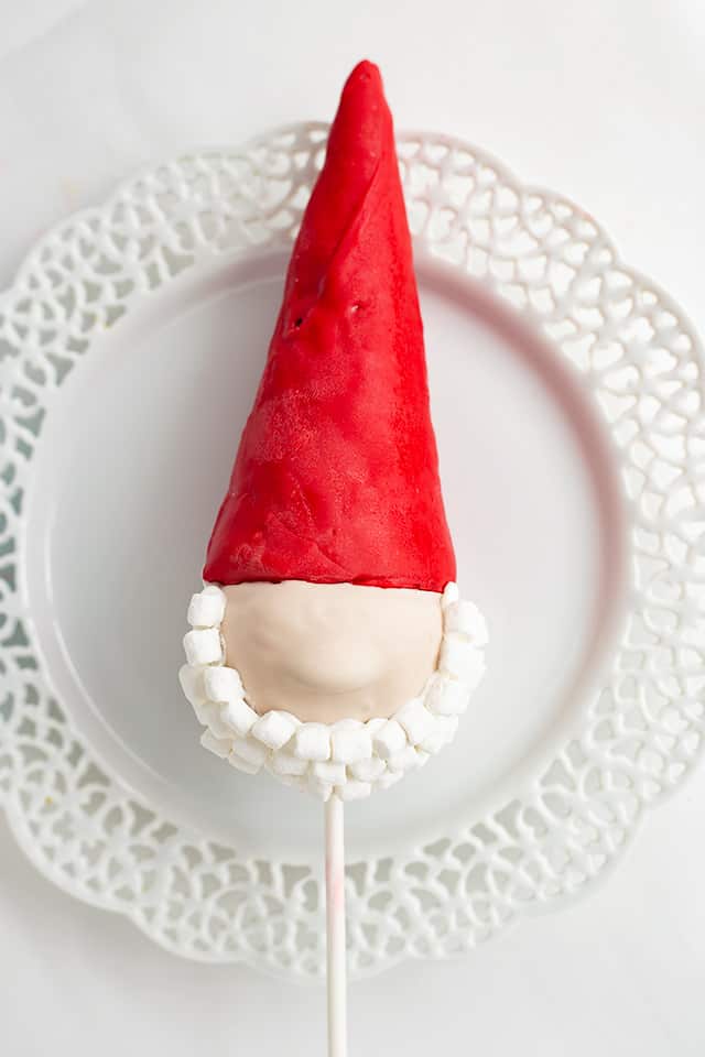 gnome cake pop on a white lace plate