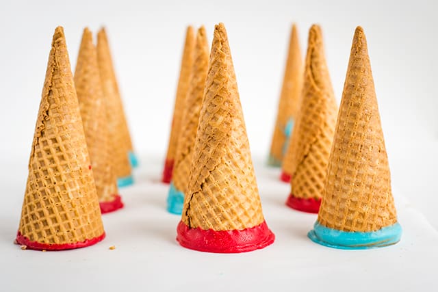Cones that have been dipped in red and blue candy melts