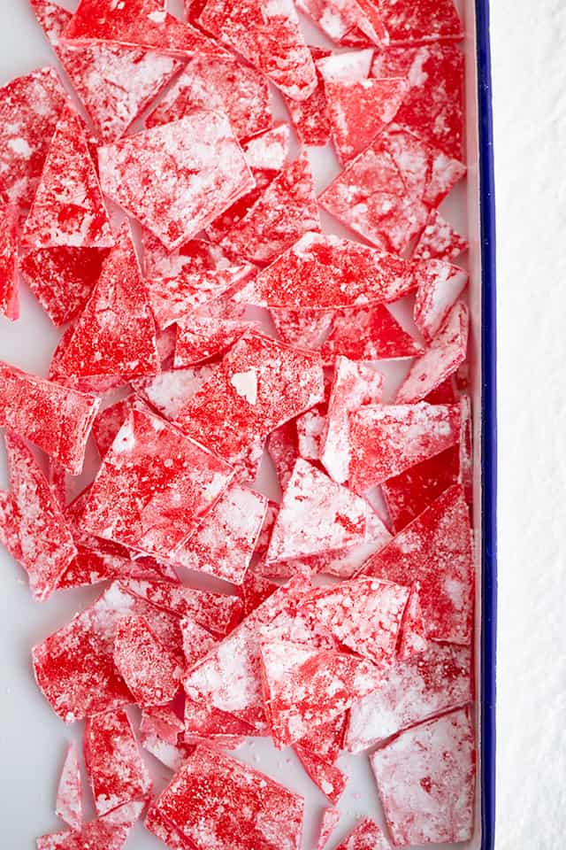 red hard candy scattered in a large white pan