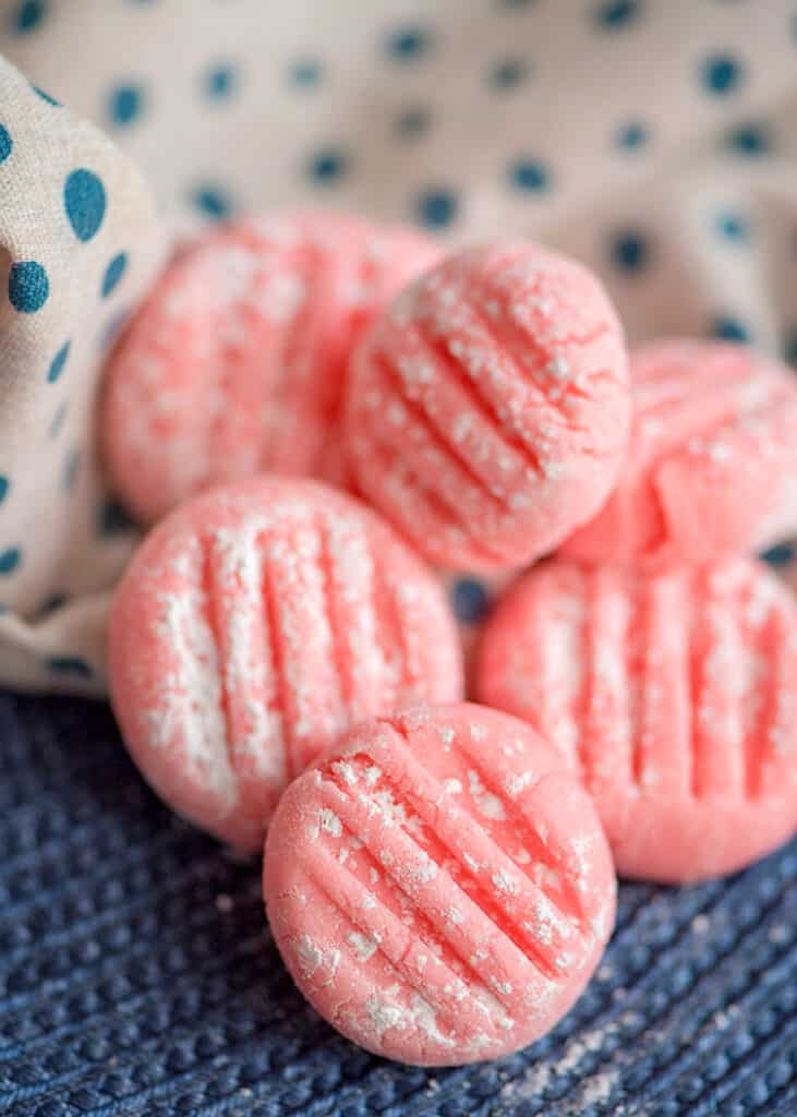 pink mints sitting on a blue placemat