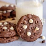 square image of a cookie propped up against a glass of milk