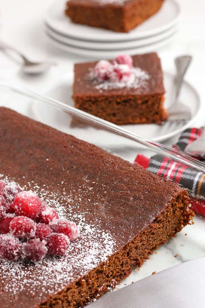 cake in a baking dish with a slice beside the dish