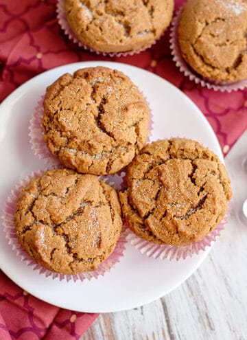 muffins on a white plate with a maroon fabric under the plate
