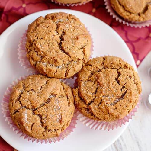 muffins on a white plate with a maroon fabric under the plate