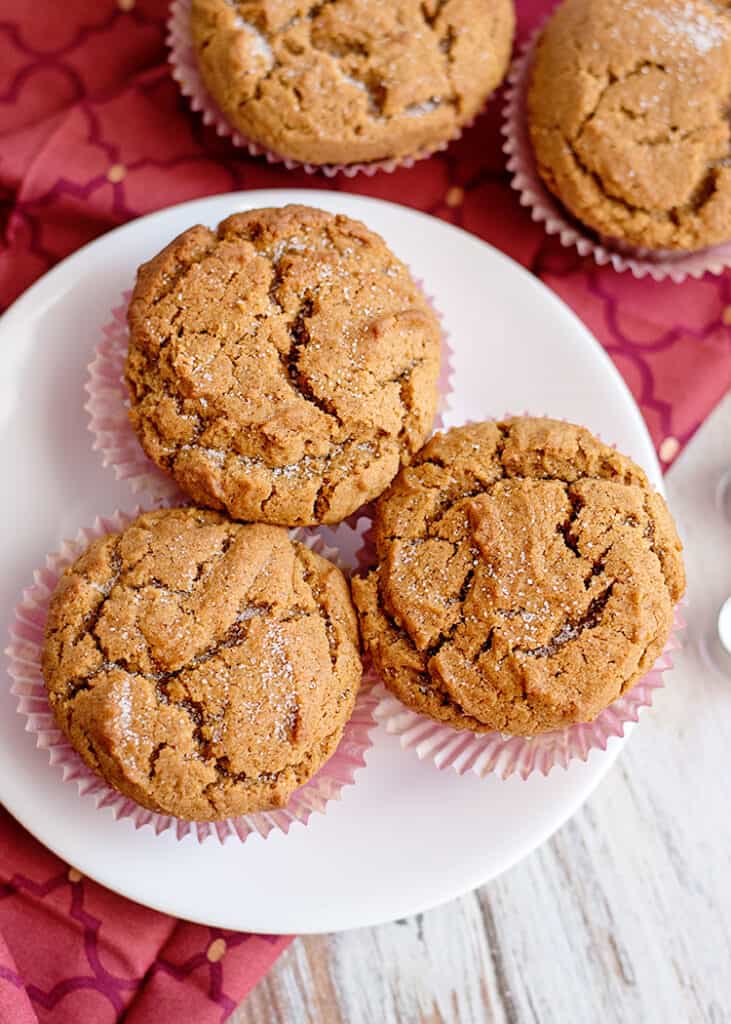 muffins on a white plate with a maroon fabric under the plate