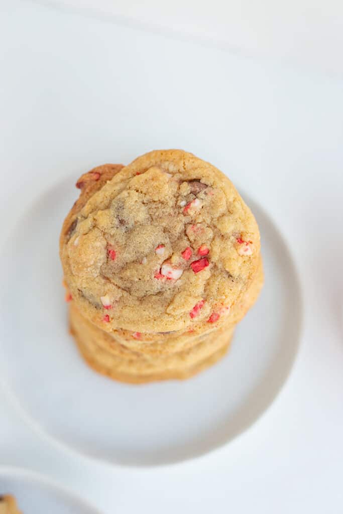 overhead photo of a peppermint chocolate chip cookie on a white dessert plate