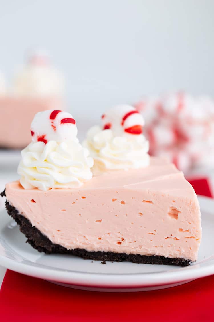 slice of pie on a white dessert plate that's on top of a red linen