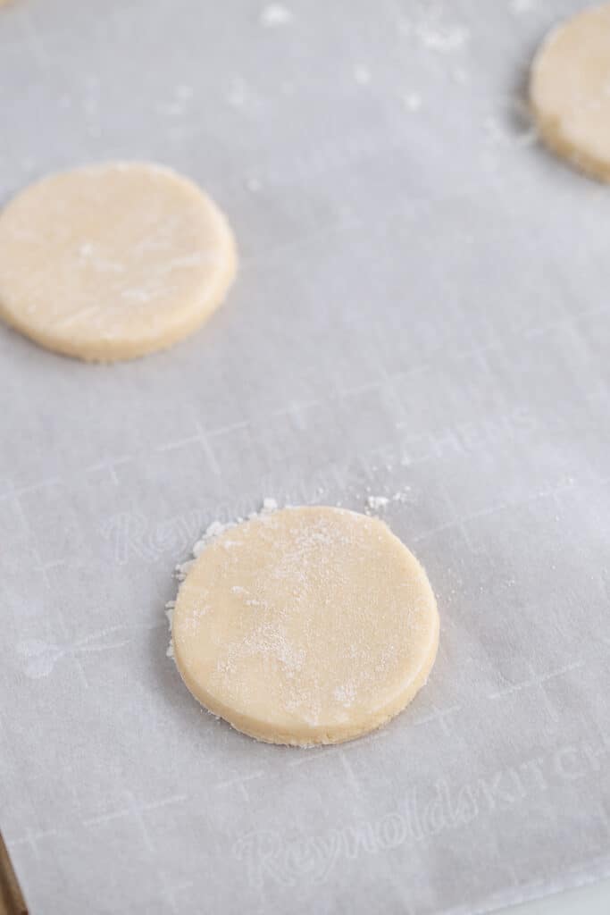 cut out sugar cookies on a parchment lined baking sheet