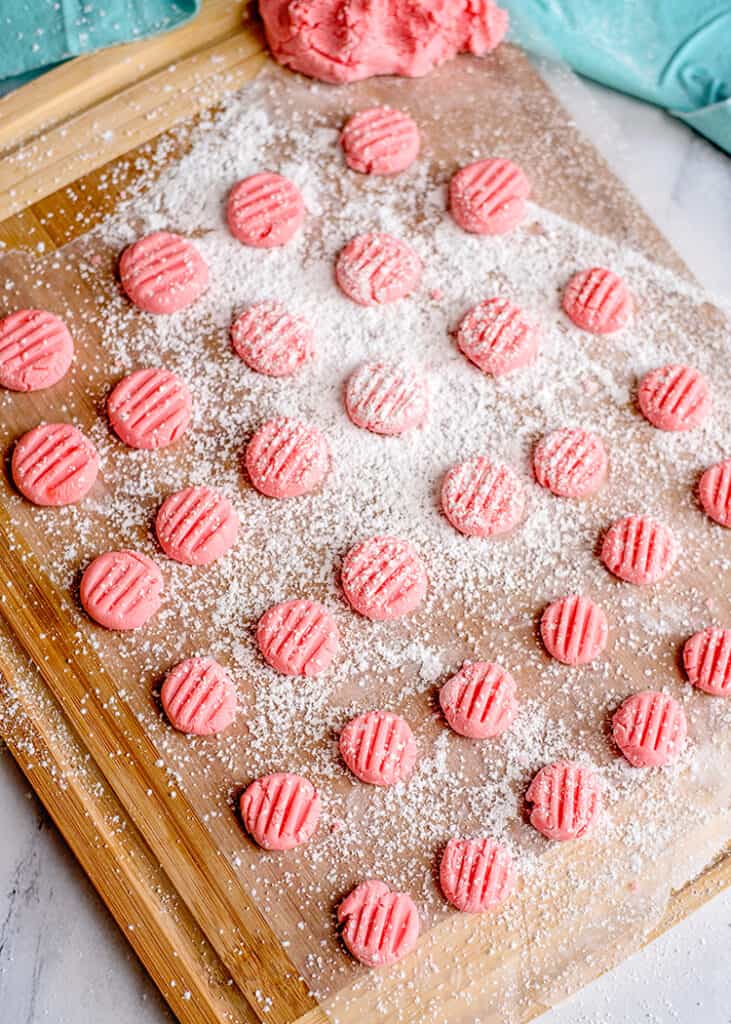 mints on a cutting board that's been dusted with powdered sugar