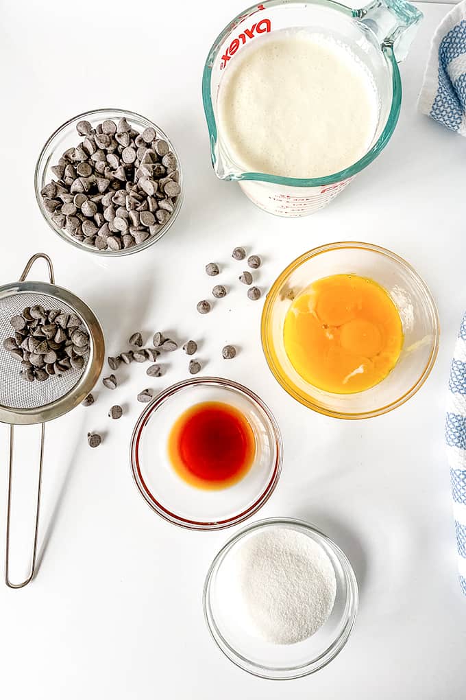 ingredients for chocolate mousse laid out with a blue and white striped fabric beside them