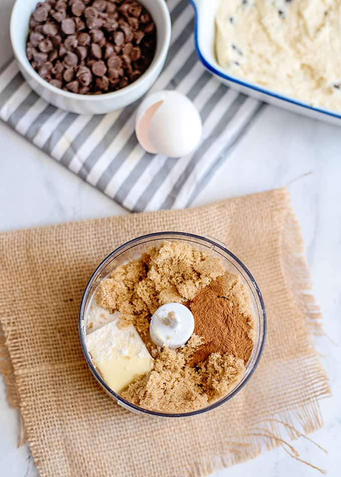 the ingredients in a food processor with burlap underneath the food processor bowl