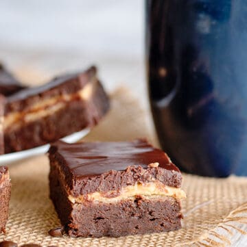 a brownie square on a piece of burlap with a blue mug behind it