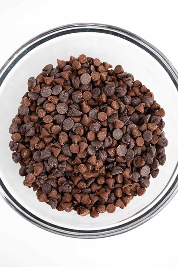 a glass bowl full of chocolate chips