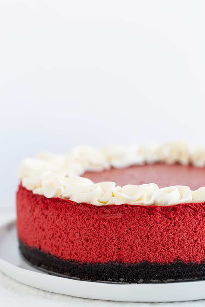 red velvet cheesecake on a white plate on a white background