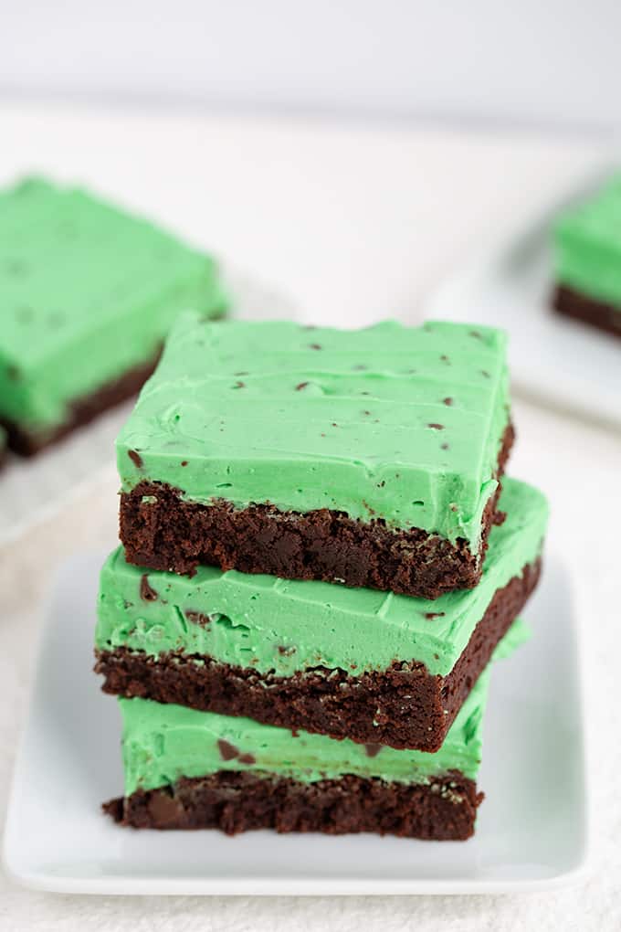 stack of brownies on a white plate on a white surface