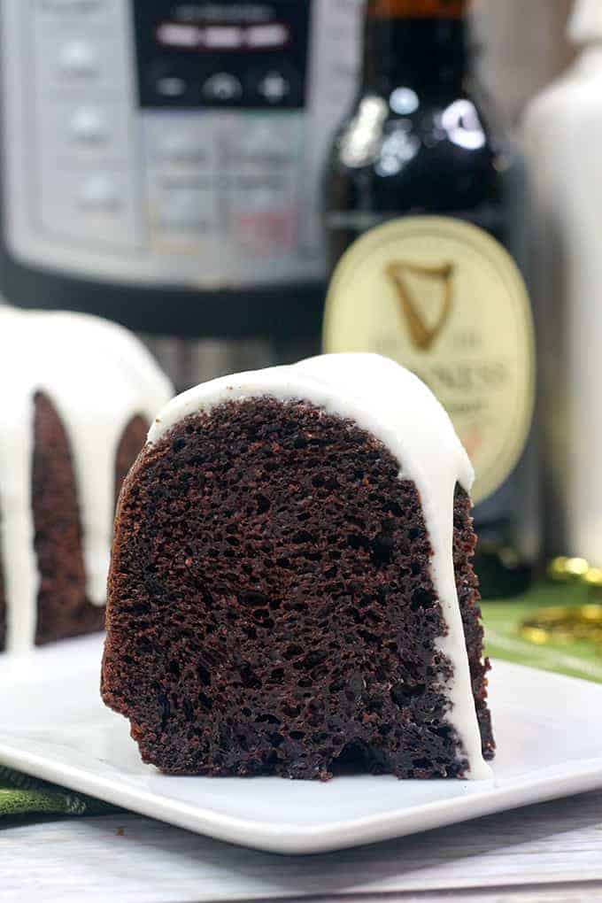 slice of bundt cake on a white square plate with a beer behind it and instant pot