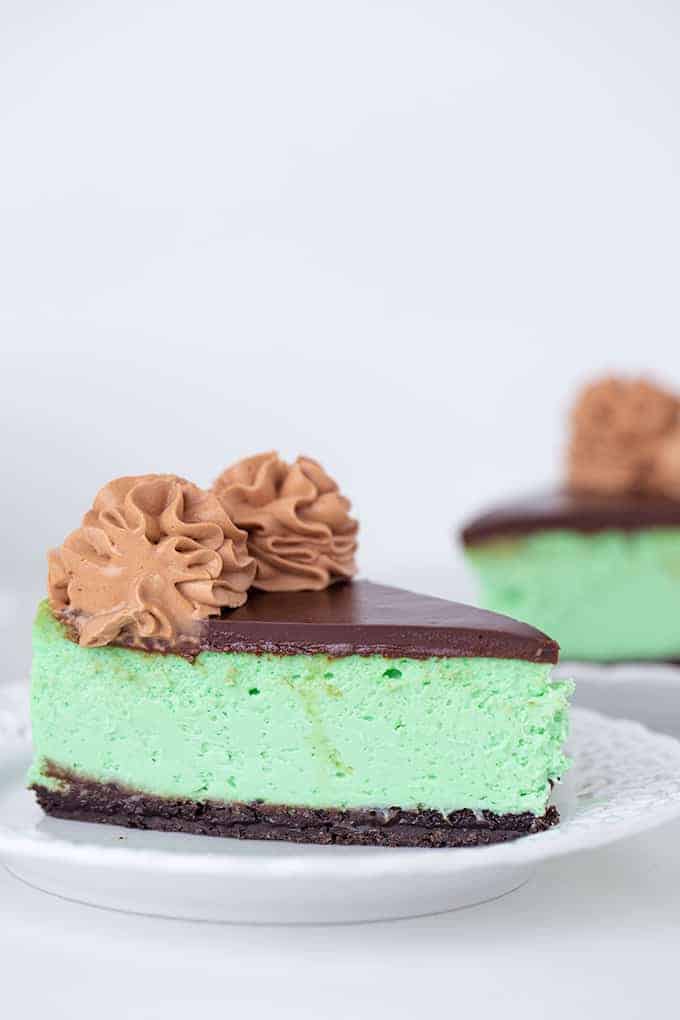 slice of green cheesecake on a white plate 