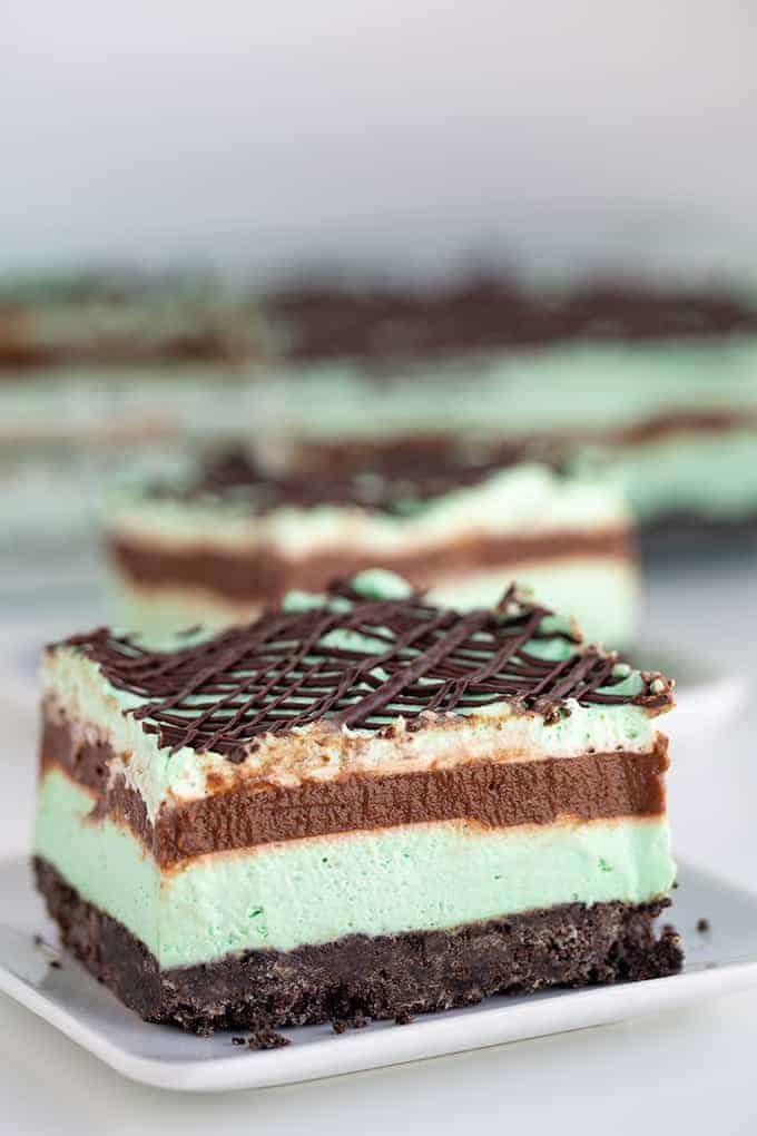 a slice of dessert sitting on a white square plate