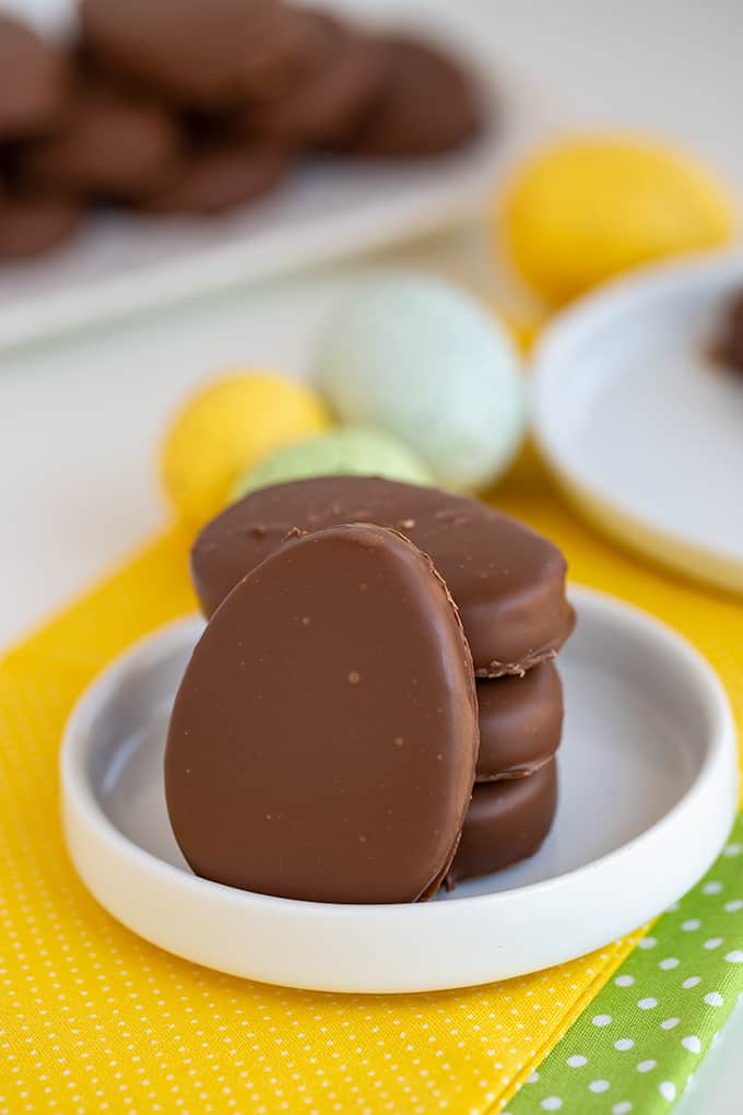 peanut butter eggs on a small white plate with yellow and green linen under them