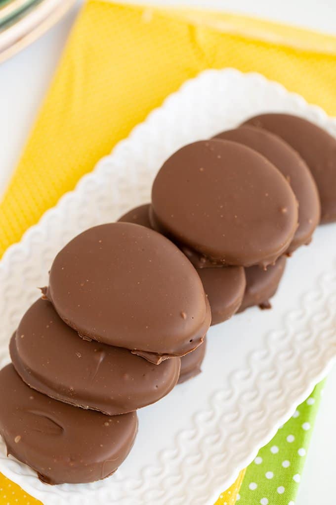 stacked peanut butter eggs on a small white platter 