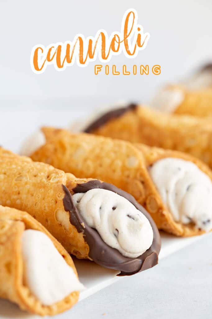 close up of the filled cannoli shells on a white surface with the recipe name in text at the top