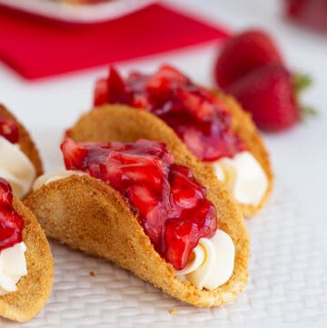 cheesecake tacos on a white cutting board on a white surface