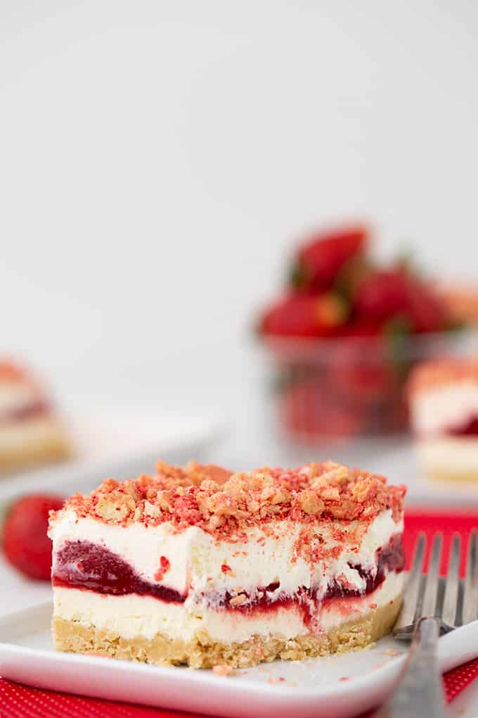 dessert on a white plate with a fork next to it and a bite taken from dessert