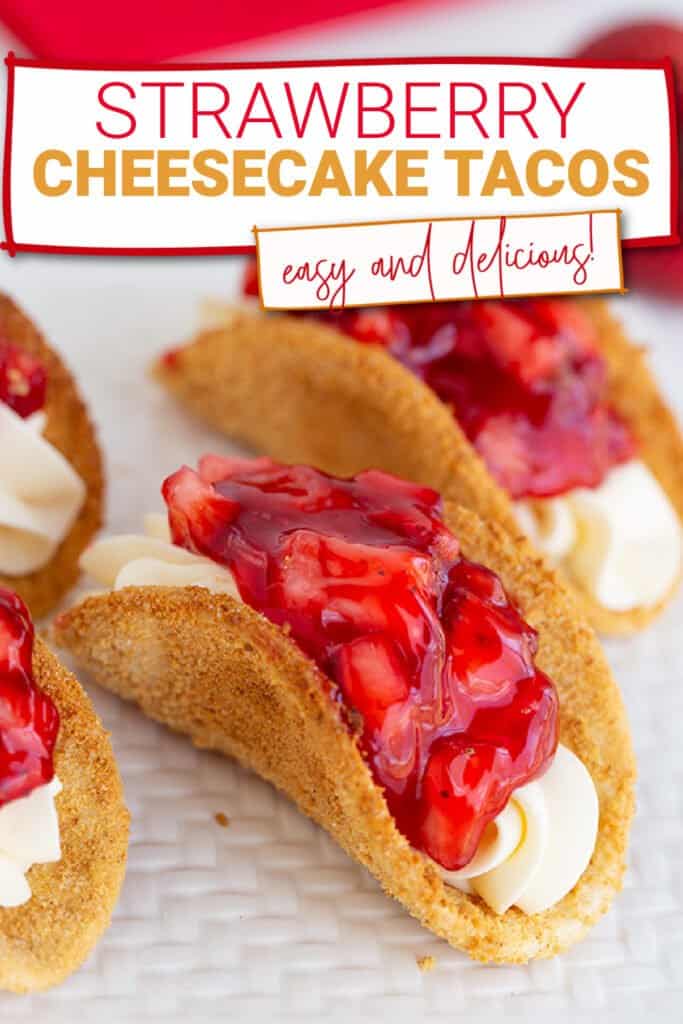 close up of a strawberry cheesecake tacos on a white textured cutting board with the recipe name in a box at the top